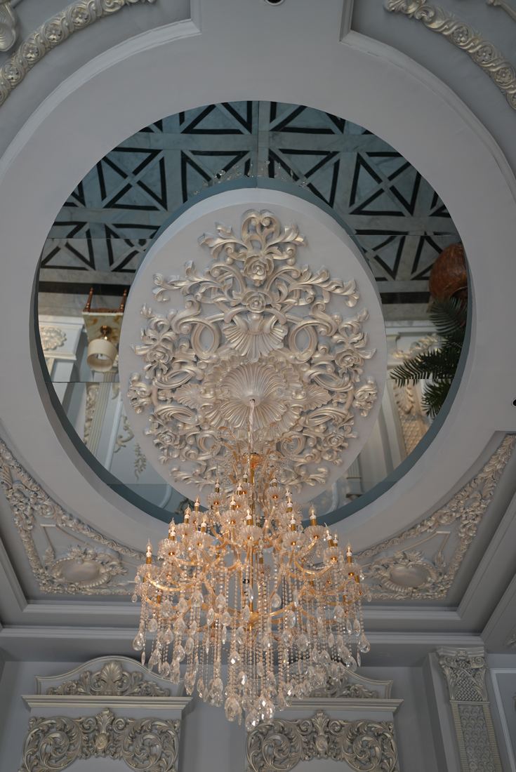 Chandelier and ornate ceiling detail at Casa Royal