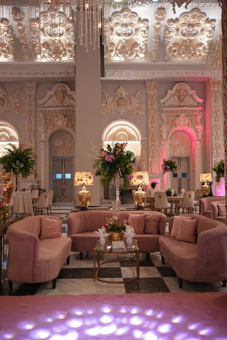 Pink lounge seating with floral decor at Casa Royal