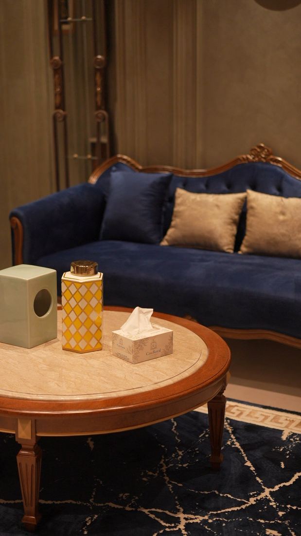 Navy velvet sofa and round table in a lounge at Casa Royal