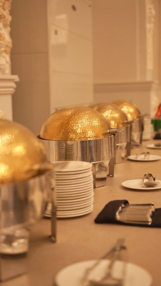 Gold serving dishes ready for service at Casa Royal
